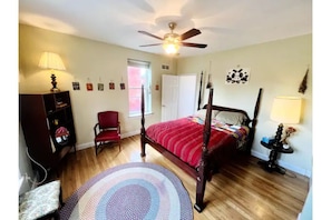 green bedroom with queen bed