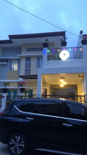 During Night time at the front of the house with Christmas light decor