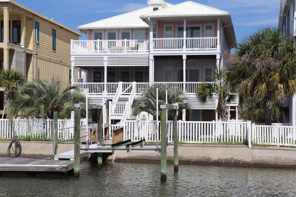 View from canal waterway.  Private dock.  Fenced yard.