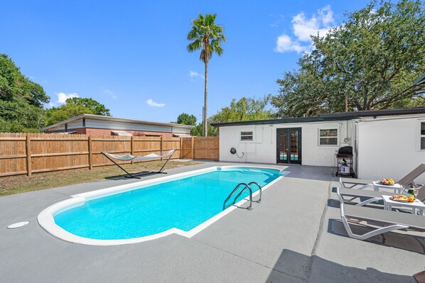 The sparkling waters of the pool beckon you to take a refreshing dip and soak up the sun.