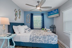 This gorgeous bedroom has a queen-size bed, drawers, bedside table and lamp. Who wouldn't want a comfortable room to rest in after a long day of activities?