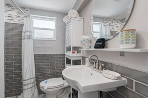 This beautiful bathroom has a walk-in shower, toilet, sink, and a vanity mirror! Never feel dirty an sticky after a day packed with fun activities! Book now!