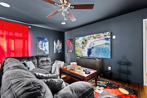 Create memories with the family in this movie room, featuring a bar and 85" TV.