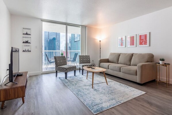 Modern open concept living space featuring a cozy sofa bed