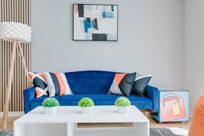 Modern open concept living space featuring a cozy sofa bed