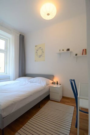 Lovely bedroom with books and a small desk. You can work easily in the flat!