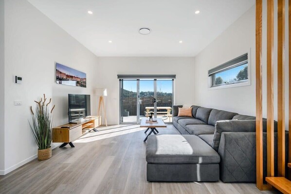 Open plan living with large Sofa with Large TV.
