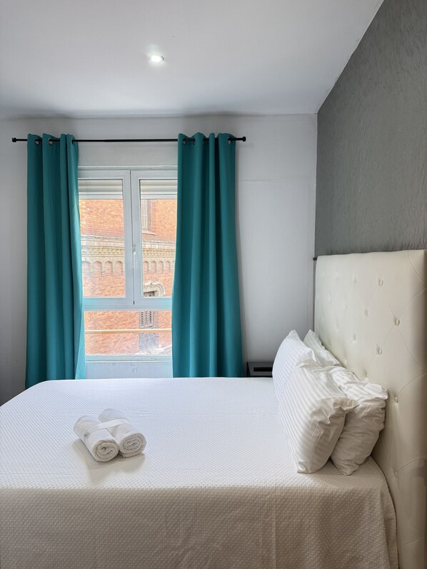 Bedroom 1 - Bedroom has a comfortable double bed with one towel per guest, air conditioning, television and storage space for your belongings. 