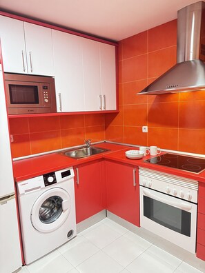The kitchen is equipped with the main appliances, crockery and other usual utensils.