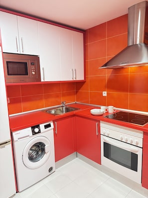The kitchen is equipped with the main appliances, crockery and other usual utensils.