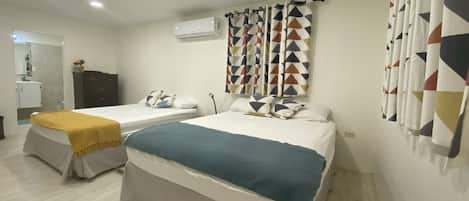 Spacious air- conditioned master bedroom with 2 king sized beds 