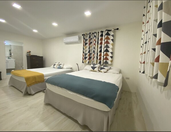 Spacious air- conditioned master bedroom with 2 king sized beds 