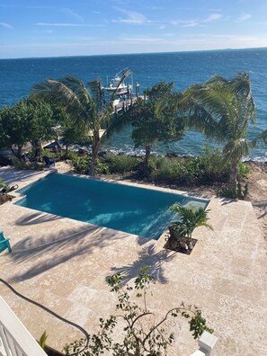 view of the pool and pool deck from the main level balcony