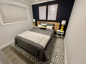 Bedroom with queen bed and closet for storage.