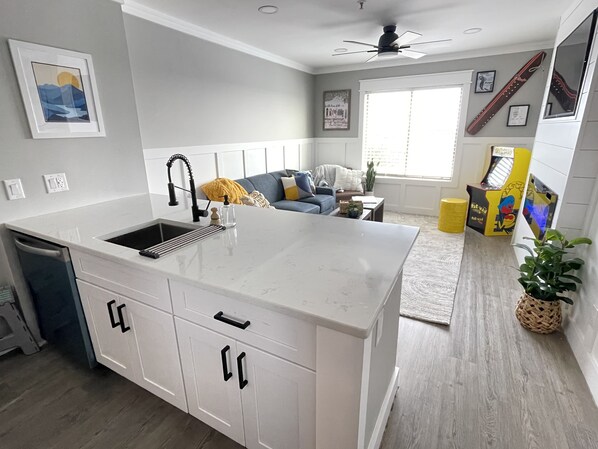 Overview of the kitchen peninsula and living room.
