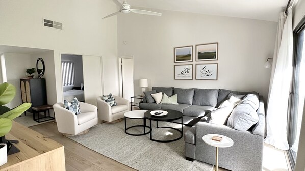 Cozy living room with oversized sectional sofa and large screen Smart TV