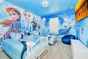 Unwind in our cozy Elsa Themed room with two beds, providing you with a peaceful retreat and a restful night's sleep during your stay.