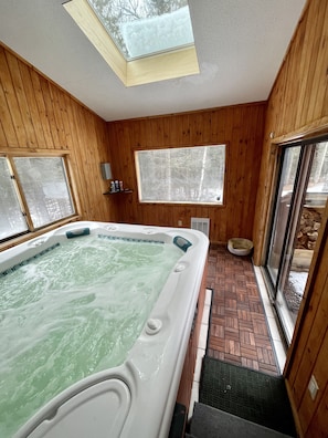 Over-sized indoor hot-tub big enough for 6 adults, doors led to private backyard