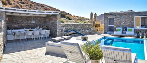 The pool area, villa and the dining area