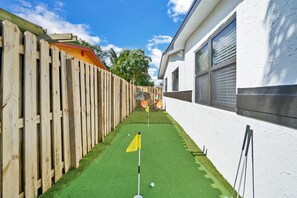 Backyard oasis complete with a miniature putting green. Perfect for honing your skills or just relaxing and enjoying the great outdoors