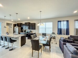 - Spacious kitchen with granite counters and stainless steel appliances perfect for group cooking
- Glass top dining table set for 8 plus a high chair ready for family friendly meals
- Lounge in plush velvet seating just steps from your favorite snacks and drinks