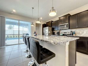 - Granite island with bar seating lets you sip wine while gazing at the sparkling pool
- Fully stocked kitchen with stainless steel appliances & plenty of prep space for your feasts
- Pendant lighting creates the perfect mood for morning coffee or evening chats