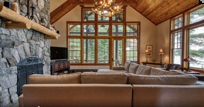 Main floor living room with access to covered porch. Views of Mirror Lake.