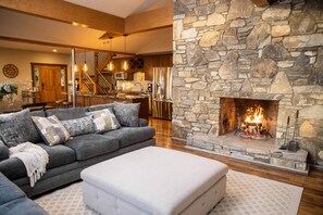 Living Room with Wood-burning Fireplace and Kitchen/Dining Room in Background