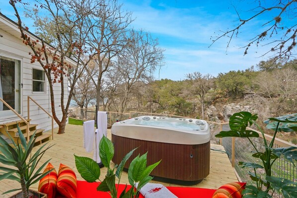 Private deck with a hot tub and fire pit