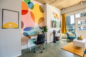 Bright and open living room with vibrant modern decor, featuring a sofa bed for an extra guest or couple
