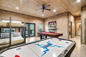 Downstairs game room with TV, pool table, air hockey, and multicade is the perfect place for kids (and adults) to gather at the end of the day!