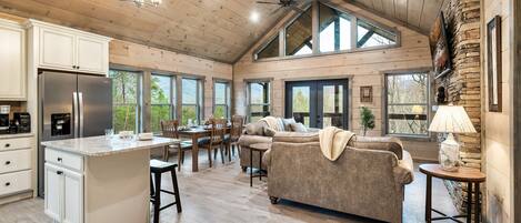 Modern cabin with vaulted ceilings and mountains in the background