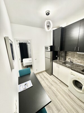 The living room has fully equipped kitchenette with a dining table and enough space to make your stay as pleasant as possible.
