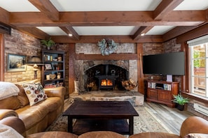 Gorgeous rock fireplace and wood beam ceilings.