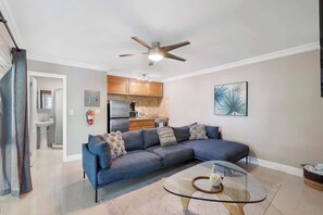 Living room includes a large couch and a large TV with Netflix and Prime!
