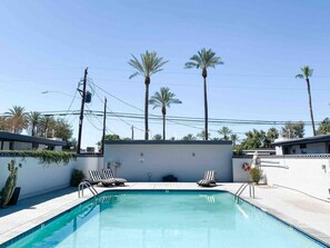 Shared community pool. Often, no one is there.  Completely enclosed and feels private. Lounge chairs available. 