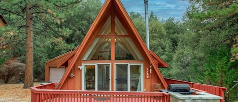 A-Frame cabin nestled in the pine forest.