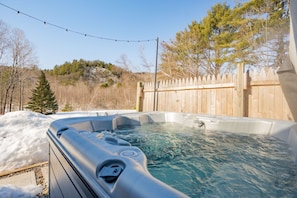 Private oasis - an outdoor hot tub nestled within. Immerse yourself in relaxation, surrounded by nature