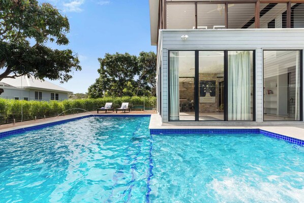 Large L-shaped swimming pool with shallow toddler section
