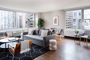 Living room with queen sleeper sofa is flooded with light and views in multiple directions