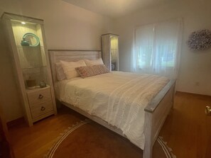 Queen guest bedroom with closet.