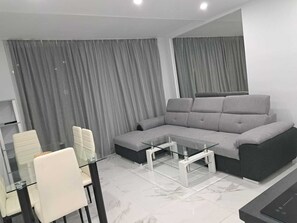 lounge with comfortable pull out sofa bed and lift up sección with spare bedding