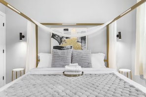 Indulge in the luxury of our tastefully designed bedroom, filled with natural light and equipped with a TV for your ultimate comfort.
