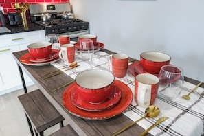 Intimate 4-seater dining area with a stylish table and comfortable chairs, perfect for sharing meals and creating cherished memories with loved ones.