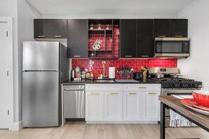 Fully-equipped kitchen with modern stainless steel appliances, ample countertop space, and a wide range of cookware, ensuring a seamless cooking experience for all your culinary needs.