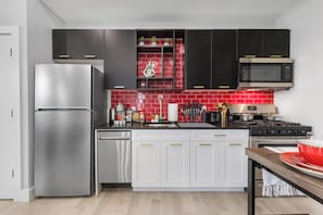 Fully-equipped kitchen with modern stainless steel appliances, ample countertop space, and a wide range of cookware, ensuring a seamless cooking experience for all your culinary needs.