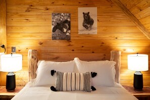 Second floor queen bedroom with locally made log furniture