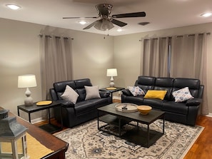 Enjoy the spacious living room with reclining sofa and love seat