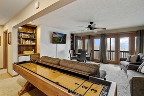 Game Tables include a Shuffleboard in the Lower Level Family Room with more in the Garage