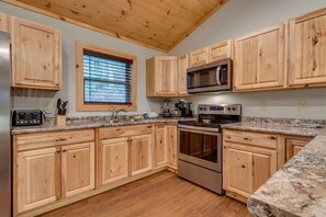 The kitchen is stocked with utensils and various pots and pans